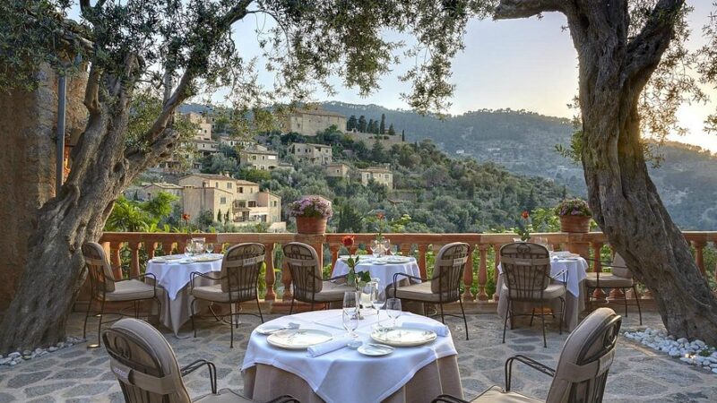 Scenic terrace at El Olivo restaurant, offering stunning views and a charming dining experience in Mallorca.