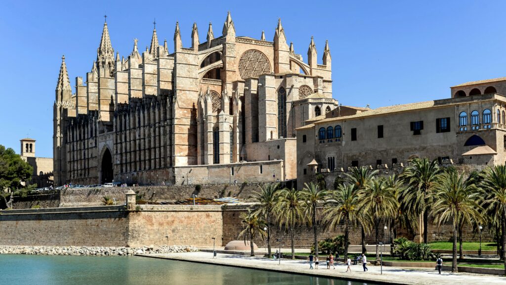 View of Palma Cathedral from Torrente, showcasing Gothic architecture and scenic surroundings.