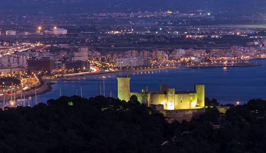 Panoramic view of Bellver Castle, highlighting its unique circular design and scenic surroundings in Palma de Mallorca.