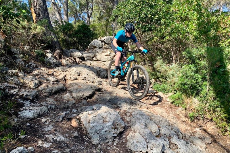 Cyclist in a steep mountain road in the heart of Mallorca.