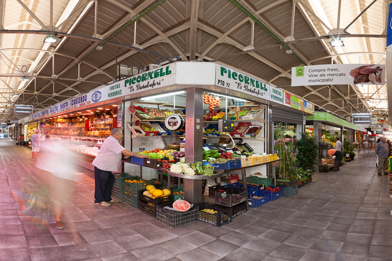 Santa Catalina Market in Palma de Mallorca, showcasing fresh produce, local delicacies, and vibrant stalls in a historic setting.
