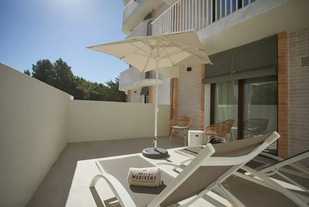 Room at Hotel Belle Marivent. A spacious area with a living room, minimalist decor, and terrace.