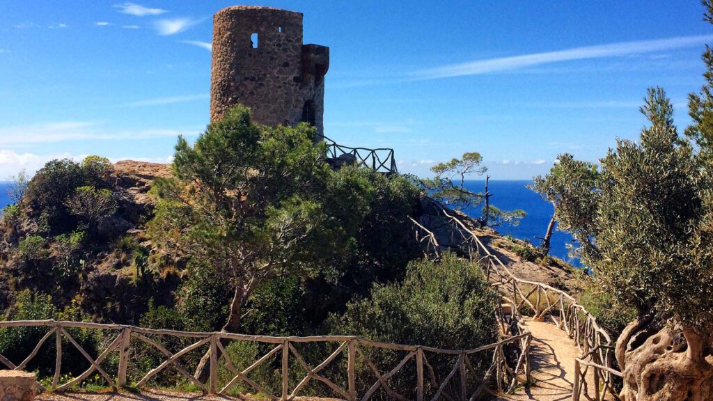 Visitors watching the sunset from Ses Ànimes lookout tower.