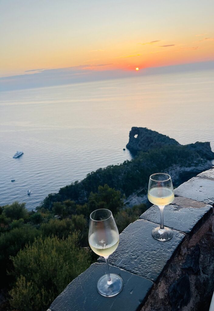 Sunset through Sa Foradada rock formation on Mallorca’s coastline.